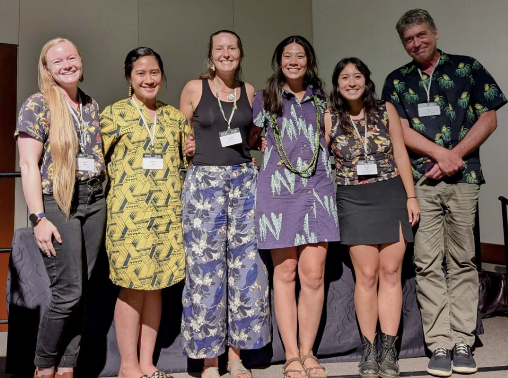 Group photo on stage at conference.